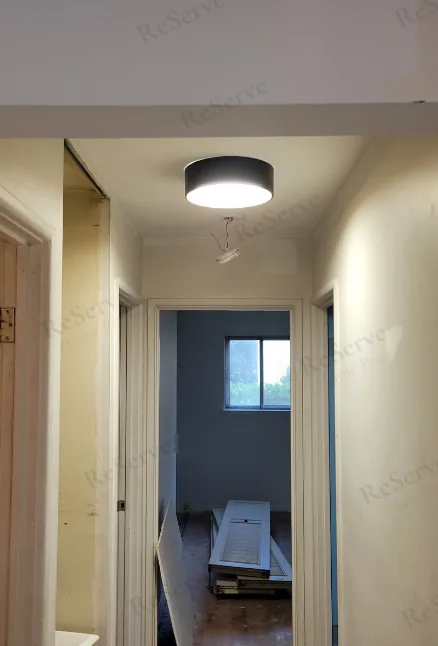 Before: Hallway rebuilt: drywall, ceiling light, doors, trim and floor.